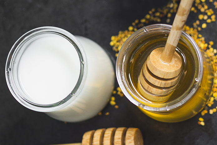 milk-pot-honey-pot-bee-pollens-stack-biscuits-textured-backdrop-copy